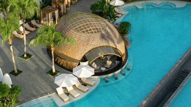 A luxurious pool area with a dome-shaped structure, sun loungers, and umbrellas. - Kimpton Aqeos Hainan by IHG (Lingshui)