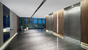 A modern elevator with a wooden finish and a digital display. - Holiday Inn Express Nanchang High Tech Zone by IHG (Nanchang)