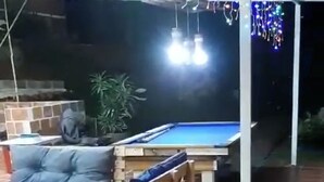 A pool table with a blue felt surface, surrounded by wooden chairs. - finca ecoturistica el paraiso (Cali)