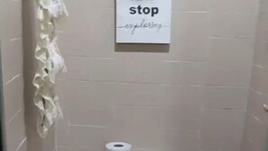 A small bathroom with a toilet, a sink, and a sign that says "never stop exploring." - finca ecoturistica el paraiso (Cali)