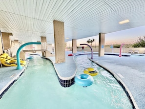 An indoor swimming pool with multiple lanes, a covered area, and inflatable rings. - Tropical Resort, Beachfront Condo with amazing oceanfront views!! 322 (North Myrtle Beach)