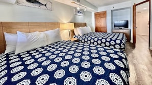 A hotel room with two beds, a TV, and a wooden headboard. - Tropical Resort, Beachfront Condo with amazing oceanfront views!! 609 (North Myrtle Beach)