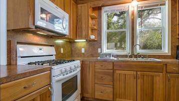 Fridge, coffee/tea maker, cookware/dishes/utensils