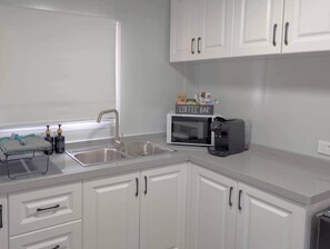 Fridge, microwave, stovetop, coffee/tea maker