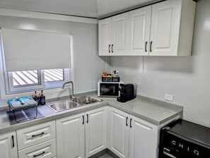 Fridge, microwave, stovetop, coffee/tea maker