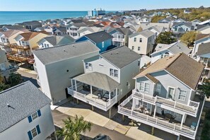 A residential area with houses featuring balconies and a view of the ocean. - Ocean Lakes Luxe, 1 Min Walk to Beach and Fire Table! (Myrtle Beach)