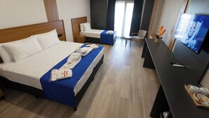 A hotel room with two beds, a desk, a TV, and a window with curtains. - Restway Hotel (Izmir)