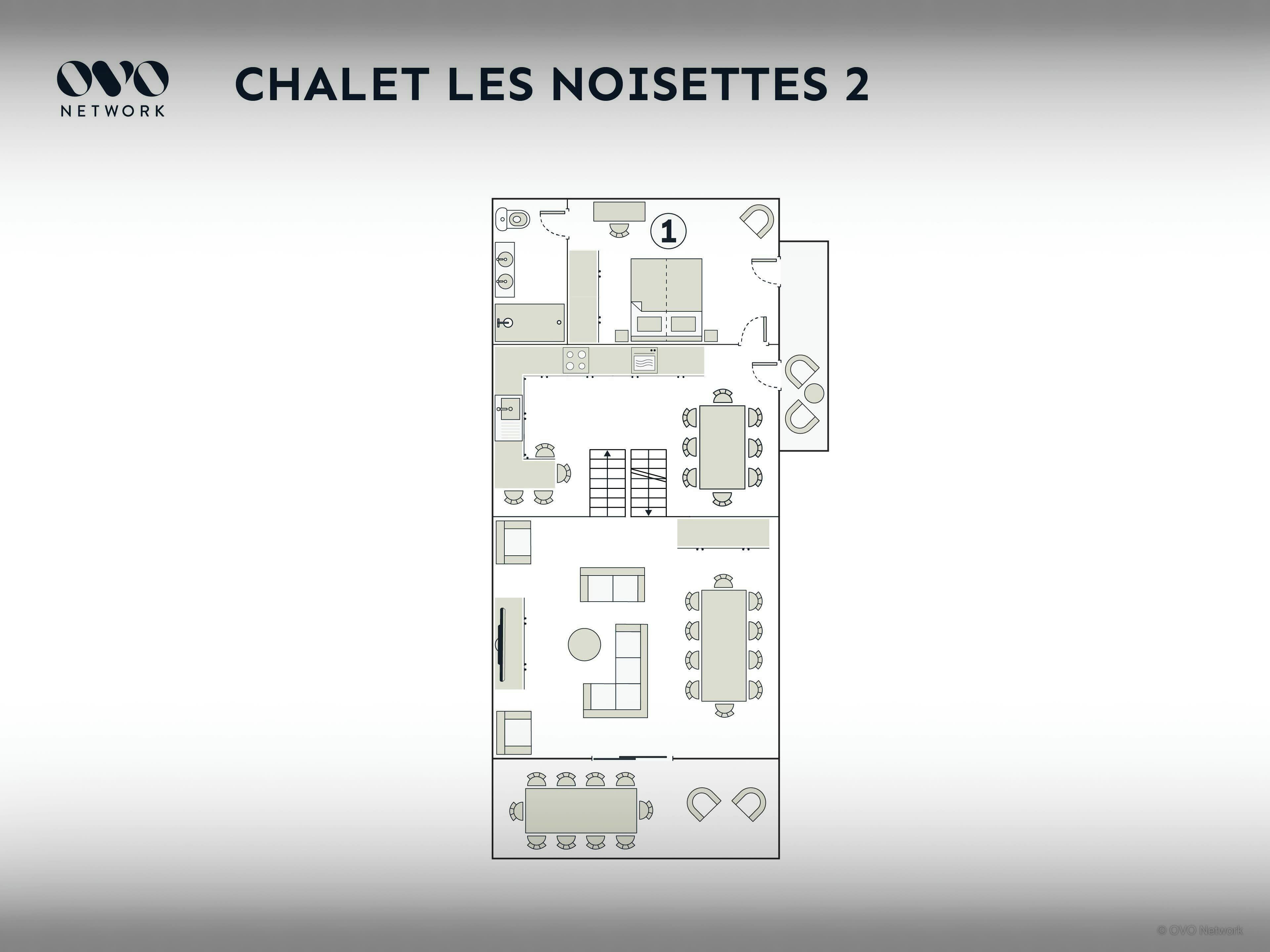 Un plan d’étage d’une chambre d’hôtel comprenant un coin cuisine, un espace repas et une salle de bain.