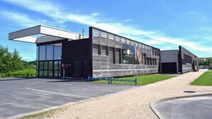 A modern building with large windows, a covered entrance, and a sign reading "PALE SPACE".