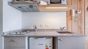 A compact kitchen with a PHILCO dishwasher, a microwave, and a built-in oven.