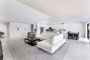 Relax in this spacious living area with a large L-shaped sofa and dining space.