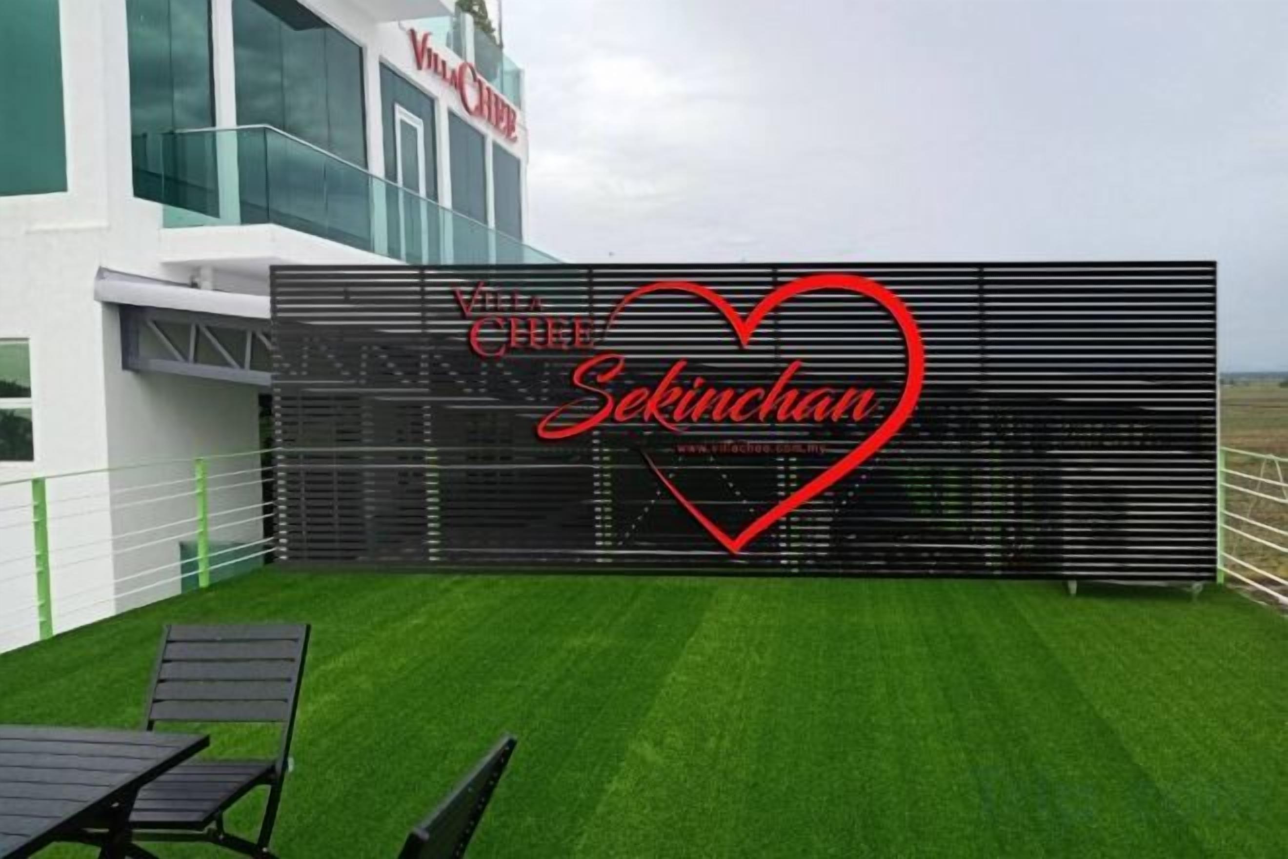 A modern building with a logo and a heart-shaped design on a black backdrop.