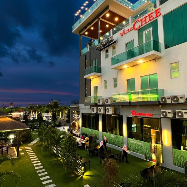 A modern building with a restaurant named 'Villa CHEE' on the ground floor. - Villa Chee (Sekinchan)