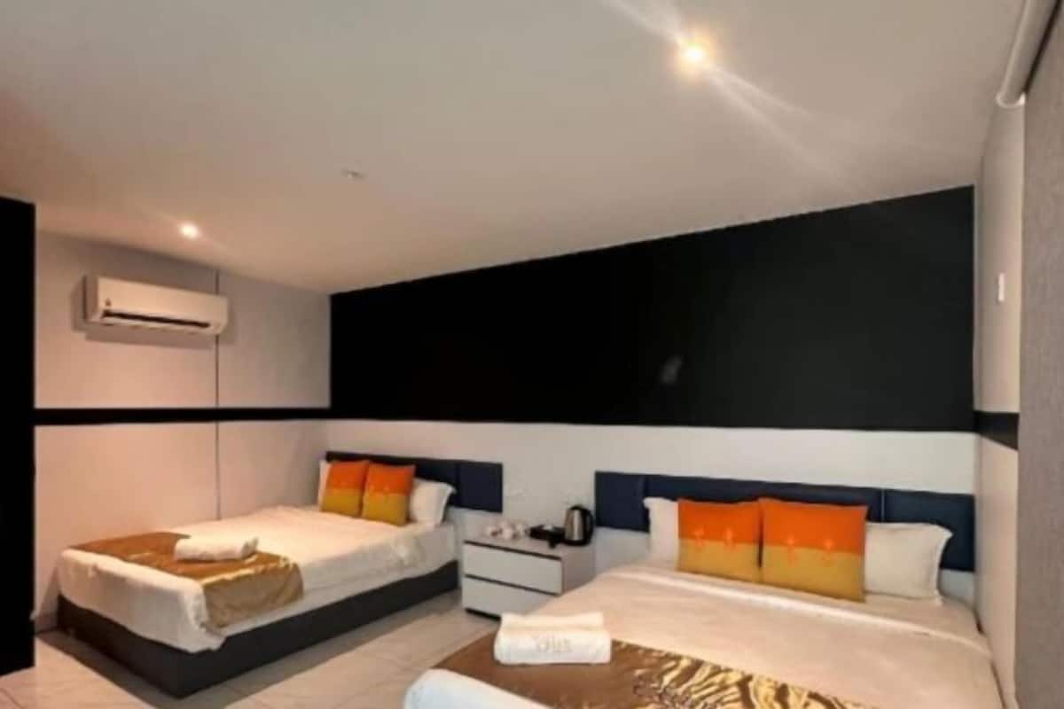 A hotel room with two beds, a nightstand, an air conditioning unit, and a large window.