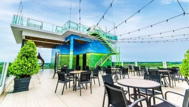 A rooftop deck with outdoor seating and a staircase leading to an upper level. - Villa Chee (Sekinchan)