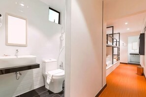 A modern bathroom with a white sink, toilet, and shower. - Villa Chee (Sekinchan)