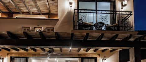 Une maison moderne à deux étages, dotée d’un balcon, d’un coin repas et d’une piscine.