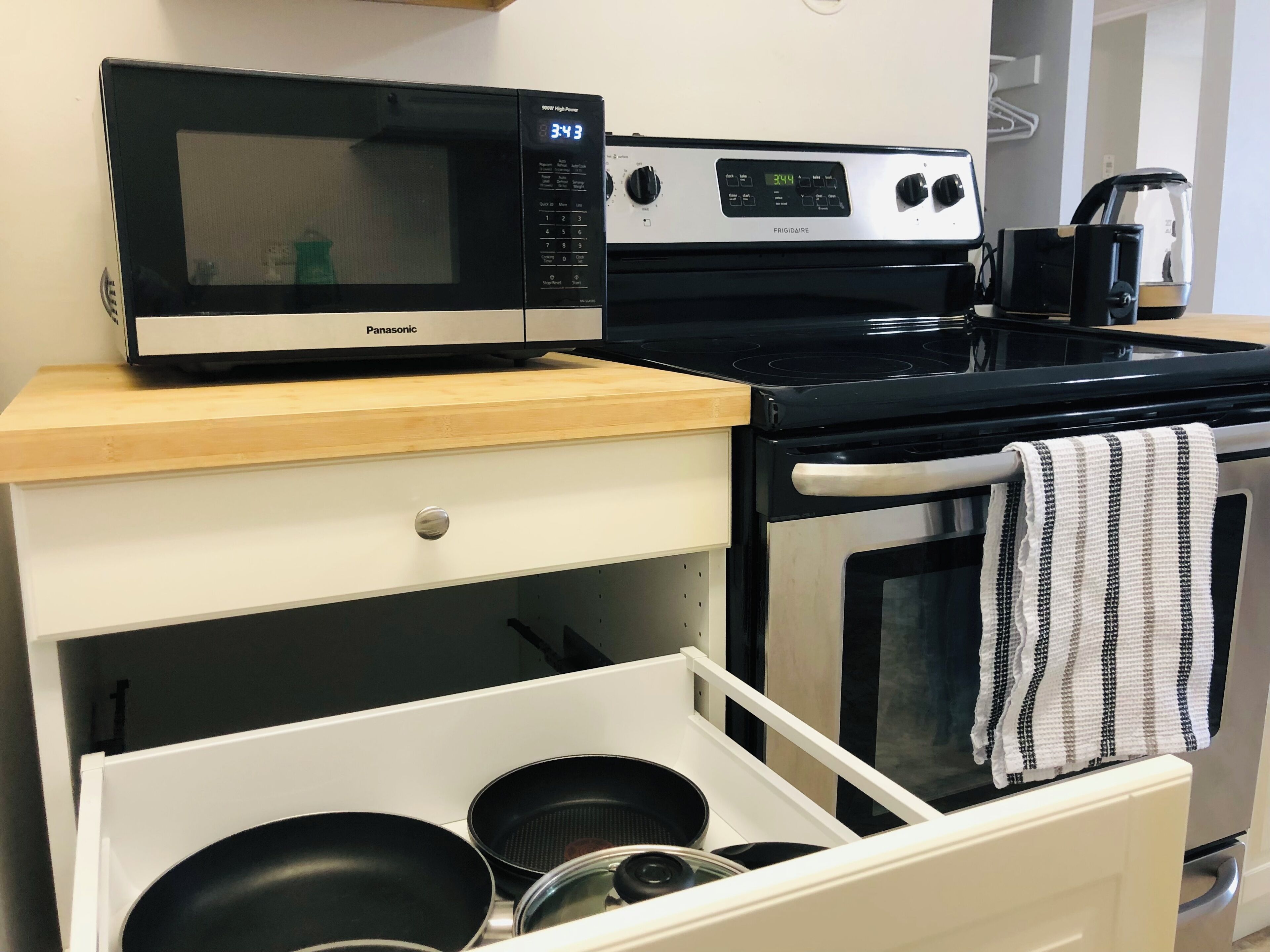 A kitchen with a microwave, stove, and oven.