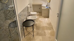 A narrow bathroom with a glass-enclosed shower, a sink, and a toilet. - HOUSE CENTER CASTRIGNANO 3 (CASTRIGNANO DEL CAPO)