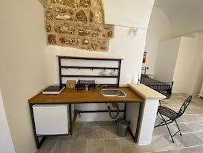 Uma cozinha compacta equipada com geladeira embutida, pia e um pequeno armário.