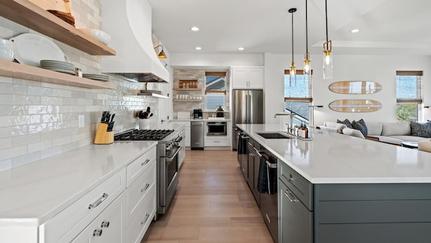 A modern kitchen with white cabinetry, stainless steel appliances, and pendant lighting. - The Golden Palms at St. Augustine Beach (Saint Augustine Beach)
