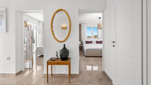 A hotel room with a large bed, a bedside table with a vase, and a view of the city. - Awesome home in Vodice (Vodice)