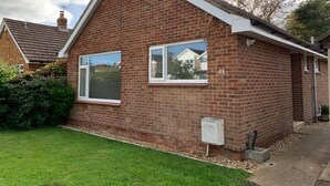 A two-story brick house with a gable roof, numbered 41, featuring two windows and a visible chimney. - 3-bed Bungalow Near Hayling Island Sailing Club (Hayling Island)