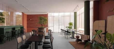 A modern conference room with a long table, chairs, and a green accent wall.