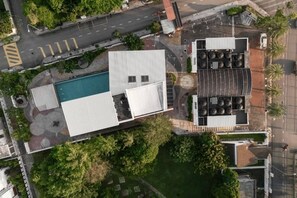 An aerial view of a building with a swimming pool, a covered outdoor area, and a parking lot. - La Vie Hotel Juru (Simpang Ampat)