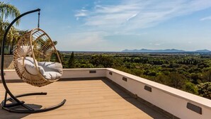 A wooden deck with a hanging chair and a view of a green landscape. - Villa 'Ines' with Private Pool, Wi-Fi and Air Conditioning (Illes Balears)