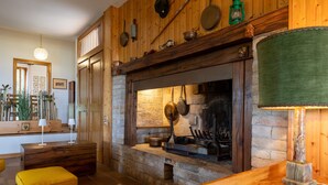 A rustic kitchen with a stone fireplace, wooden beams, and a wooden counter. - Villa 'Eleonora' with Private Pool, Private Garden and Wi-Fi (San Vivaldo)