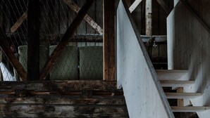 A rustic wooden interior with a staircase, wooden walls, and framed pictures. - Room 'Stùä' with Mountain View, Shared Terrace and Wi-Fi (Dosoledo)