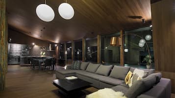 Deluxe Villa | Living area | 65-inch flat-screen TV with digital channels