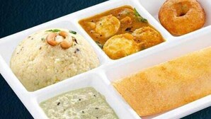 A meal with rice, curry, a bread roll, and a side dish. - Forest Transit Hotel (Coimbatore)