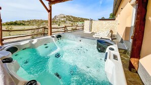 A hot tub under a wooden pergola with a view of a mountainous landscape. - Vacation home Lea by Interhome (Karlobag)