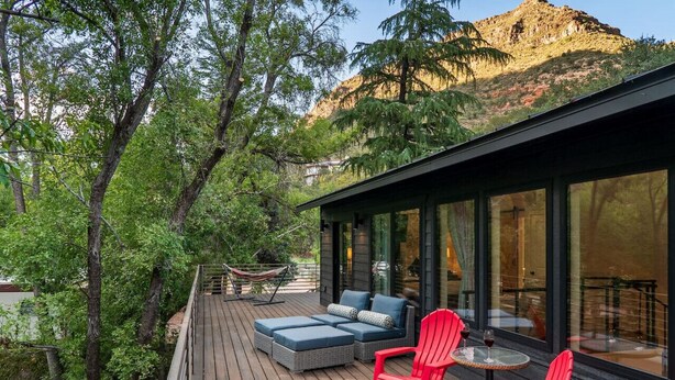A deck with outdoor seating, a hammock, and a view of a mountain. - Stylish Oak Creek Home w/ 2 Suites, Spa & Firepit (Sedona)