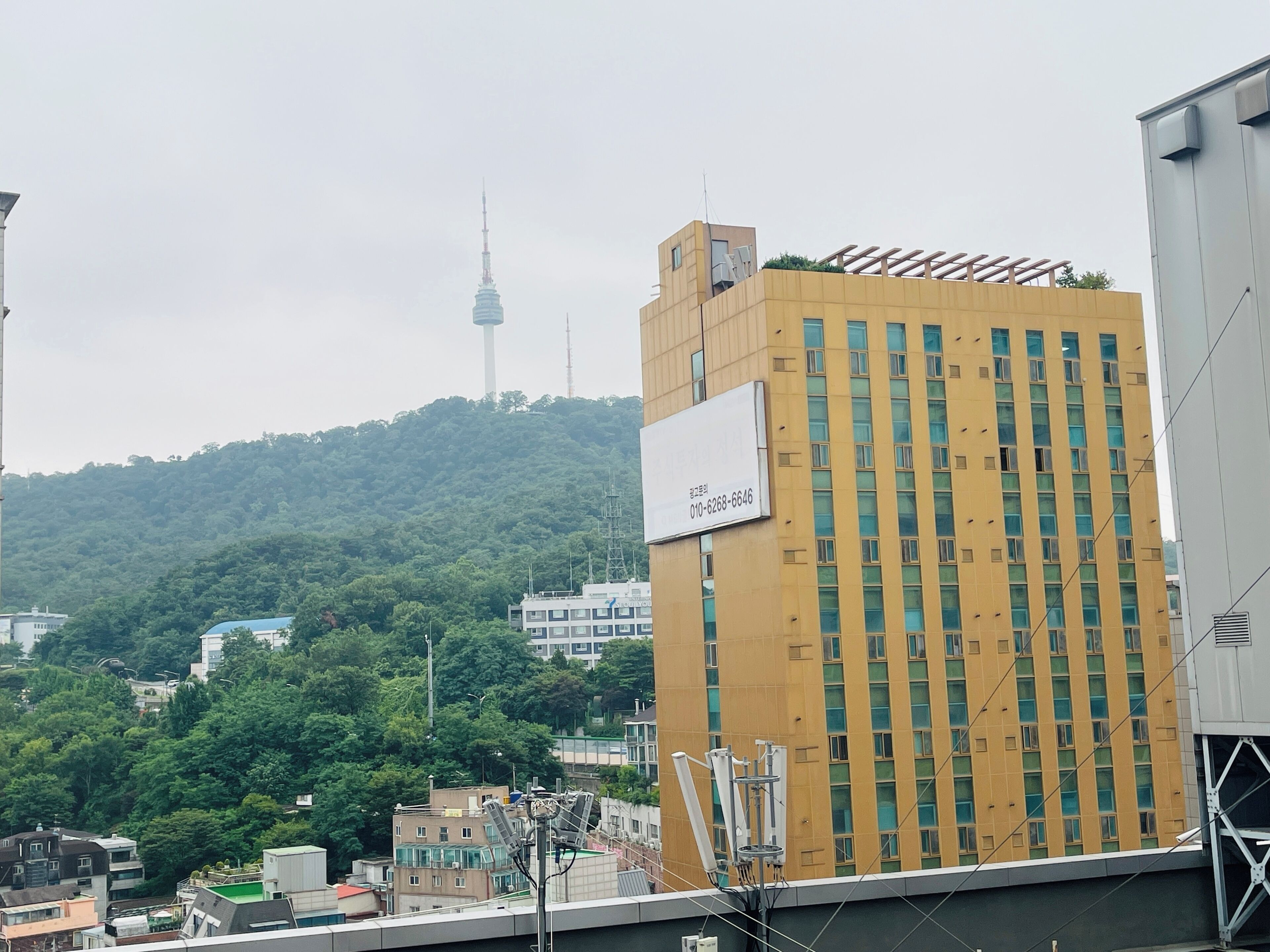 A multi-story building with a prominent billboard on the side.