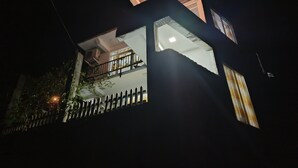 A multi-story building with a balcony and large windows. - C&D Ella (Ella)
