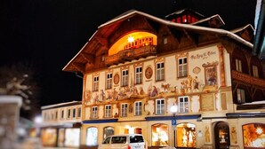 A building with a balcony, a sign with the year 1775, and a van parked in front. - Guest Rooms "König-Max-ll" and "Ludwig-Thoma" (Oberammergau)