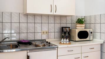 Fridge, microwave, stovetop, coffee/tea maker