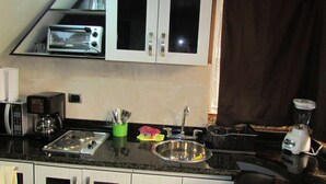 A kitchen with a microwave, toaster, coffee maker, sink, and a blender. - One Bedroom AC Hot Tub 1 block Parque Poblado (Medellin)