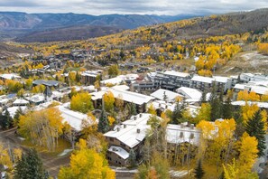 A residential area with houses and buildings surrounded by autumn-colored trees. - Luxury Resort Ski In Ski Out Studio (Snowmass Village)