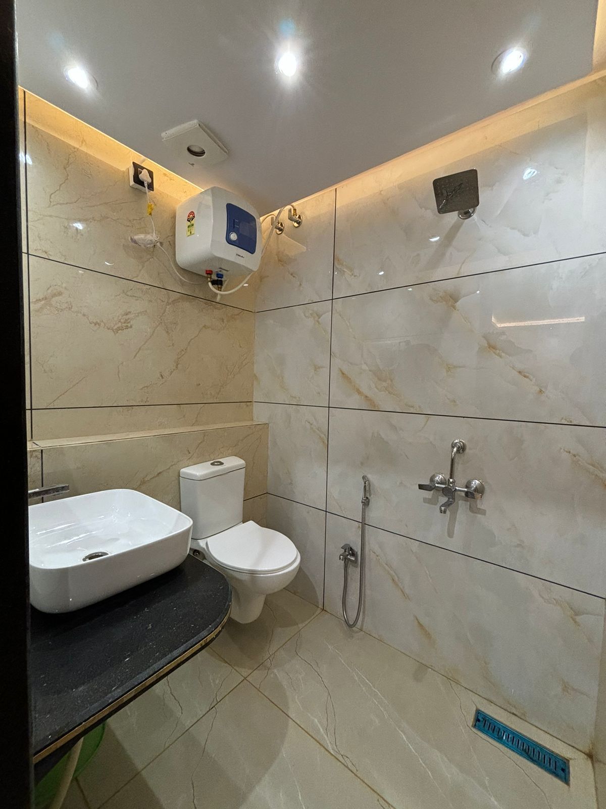 A modern bathroom with a toilet, bidet, and sink.