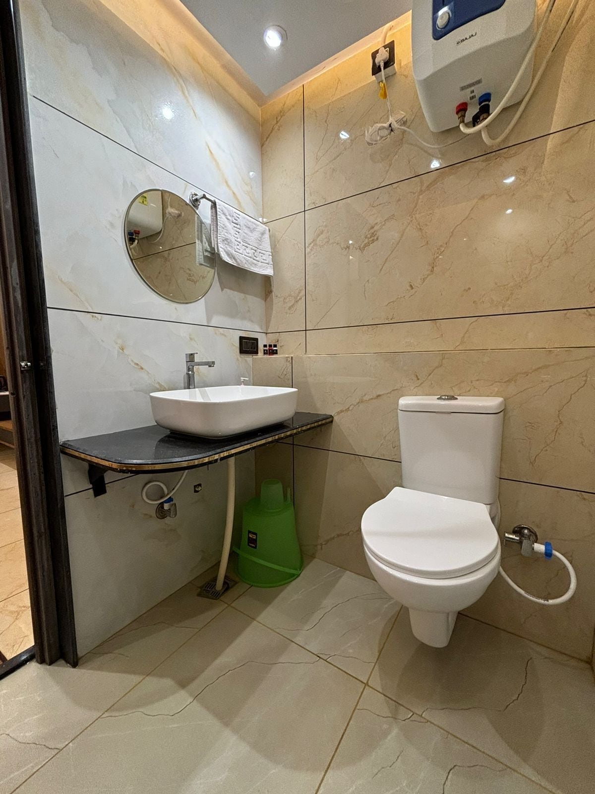 A bathroom with a sink, toilet, and a mirror.