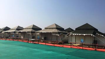 A row of tents with a red walkway in between.