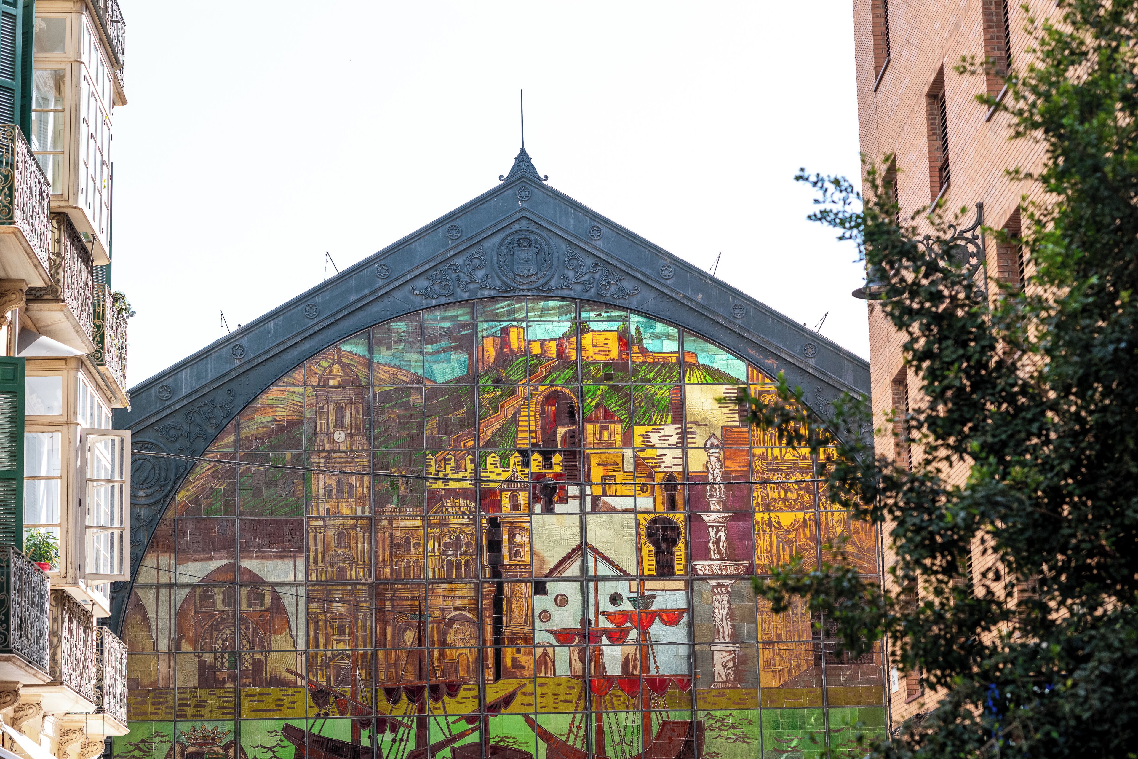 A building with a distinctive arched glass facade featuring historical architectural elements.