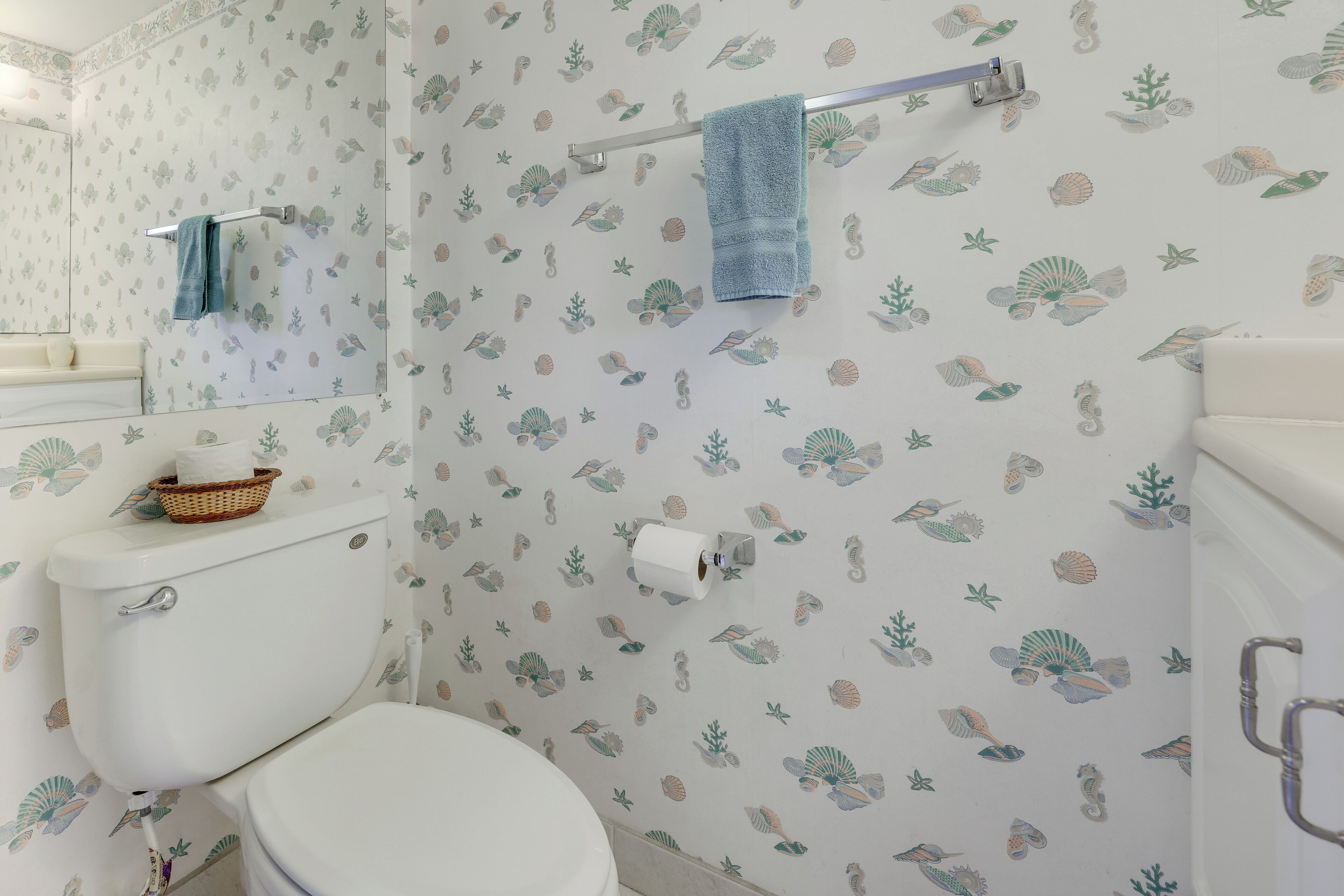 A bathroom with a toilet, a sink, and a shower.