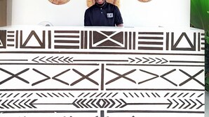 A reception area with a wall decorated with woven baskets and a large sign reading "YASA". - Yasa Boutique Hotel (Nungwi)