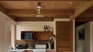 A modern kitchen with wooden cabinets, a built-in microwave, a stove, and a sink.
