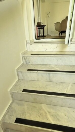 A staircase with white marble steps and black risers. - Vacation Apartment in the Heart of Fethiye (Fethiye)